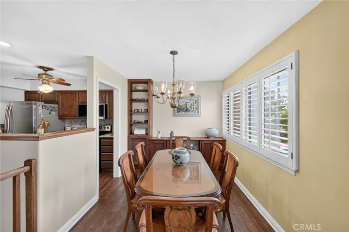 Dining room featuring windows with plantation shutters and serene views