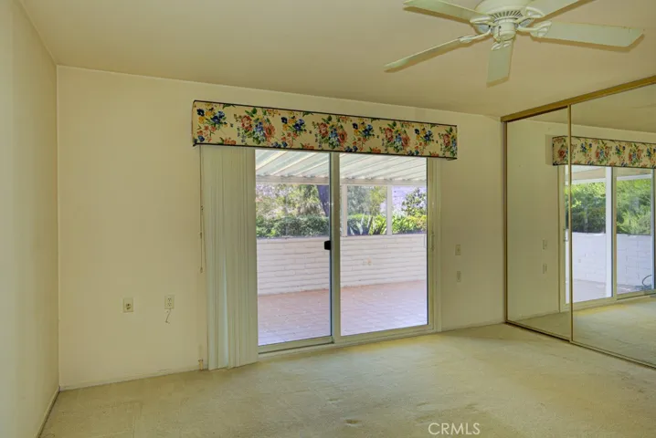 Primary bedroom suite has direct access to the enclosed rear patio.