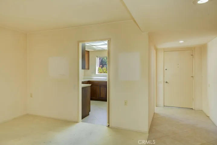 Entry to the kitchen from the living room. Front door at right.