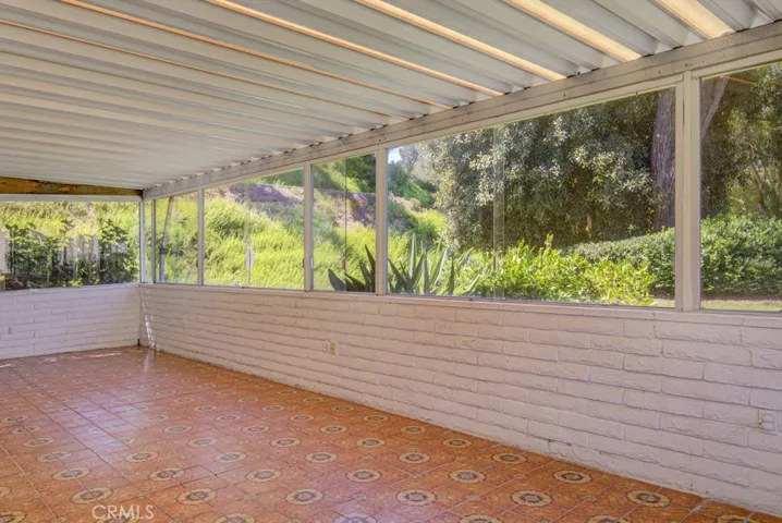 Huge covered rear patio can be directly accessed from the living room and the primary bedroom.