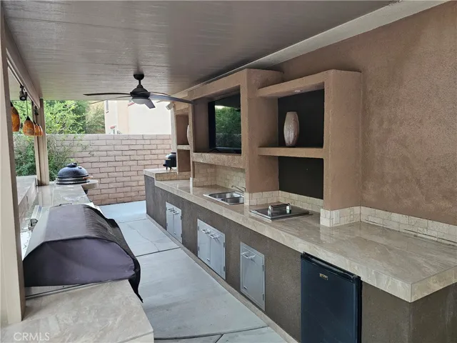 Outdoor kitchen with refrigerator, stainless cooler, sink, and Stainless cabinets