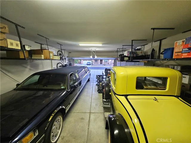 Oversized garage can fit 4 vehicles, tantum style. With ceiling storage units, offering more space in the garage
