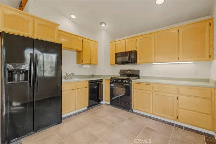 Kitchen with fridge, dishwasher, stove and microwave.