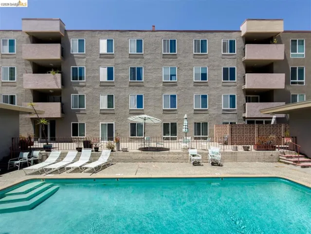 Outdoor swimming pool with integrated steps, surrounded by a concrete deck