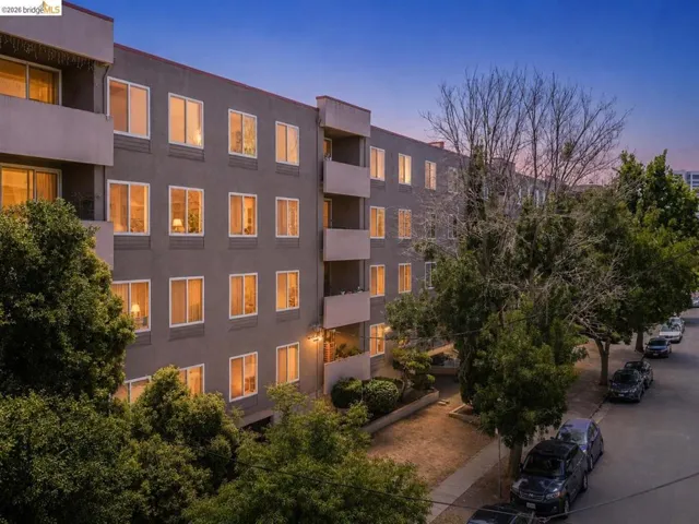 Multi-story building featuring a neutral-toned facade with multiple balconies