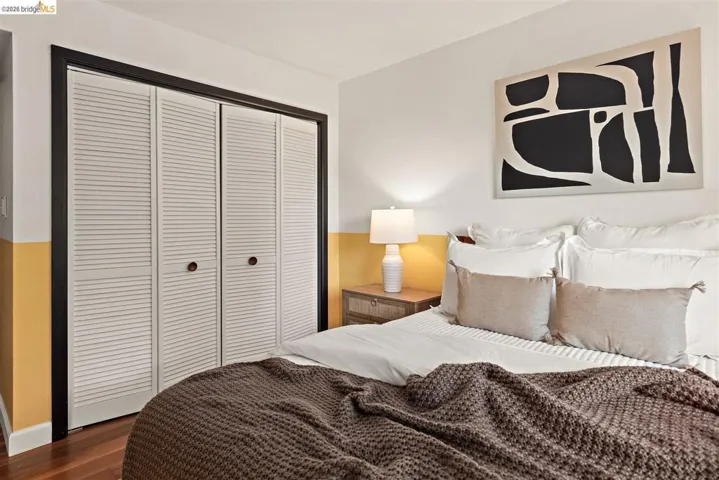 White louvered bi-fold closet doors framed in black trim