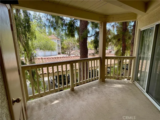 Tree lined balcony and covered designated parking space