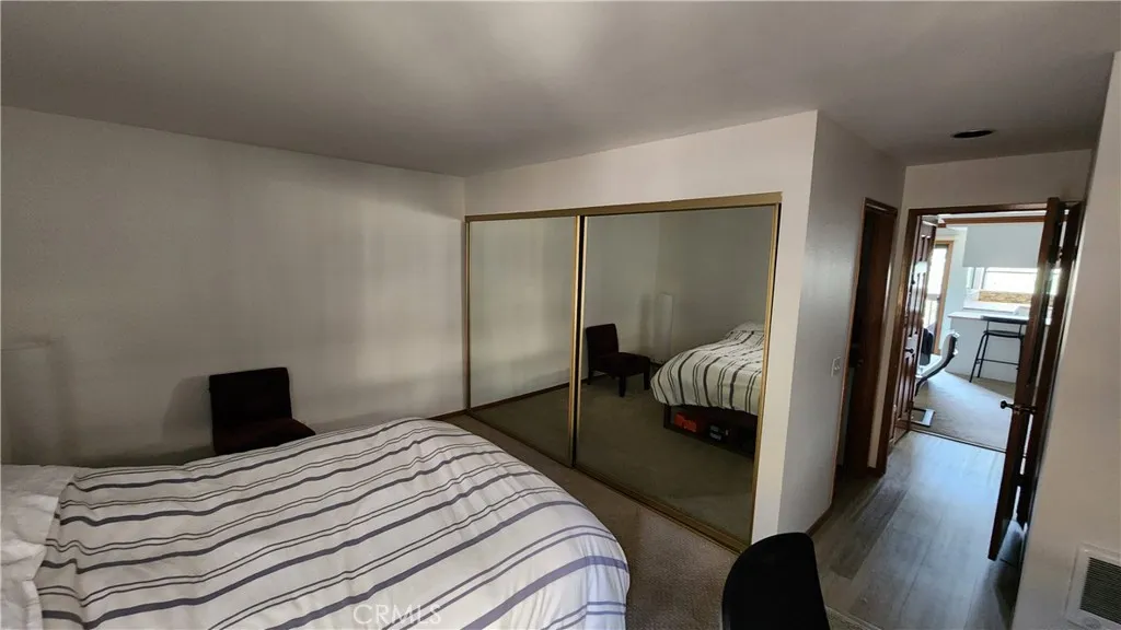 Bedroom features luxury vinyl plank flooring and carpet