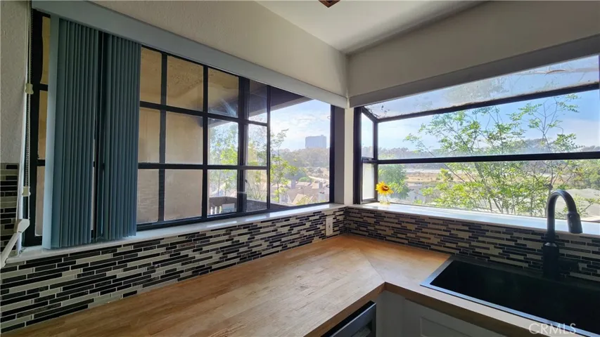Newer countertops, sink faucet and cabinets enjoy a great view from corner windows.