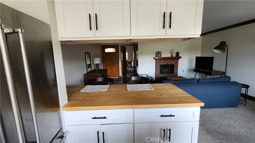 Pass through from kitchen to breakfast bar.  Newer European style cabinets, and stainless steeel refrigerator.