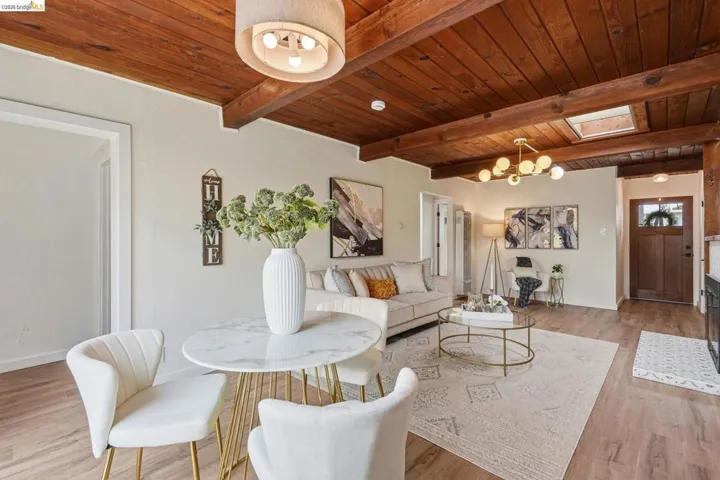 Living area featuring exposed wood-beam ceilings and wood-finish flooring