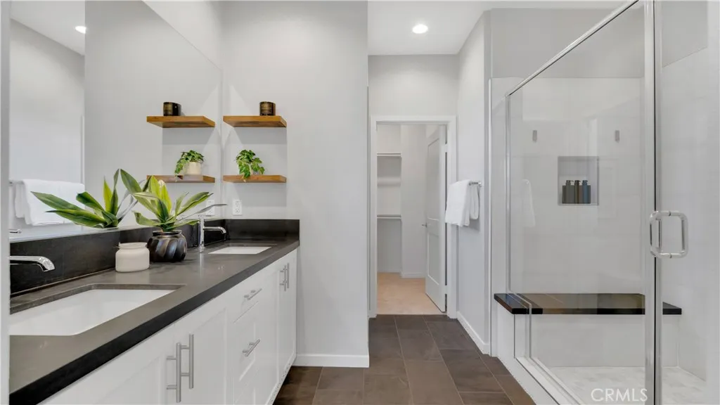 Primary Bath - Dual Sinks with Matte Granite Counters, Marble Shower, and Walk-In Closet