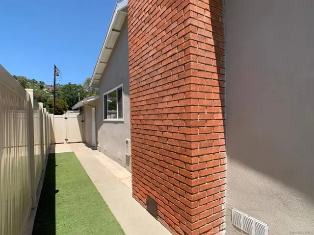 Low maintenance dog run area with artificial turf.