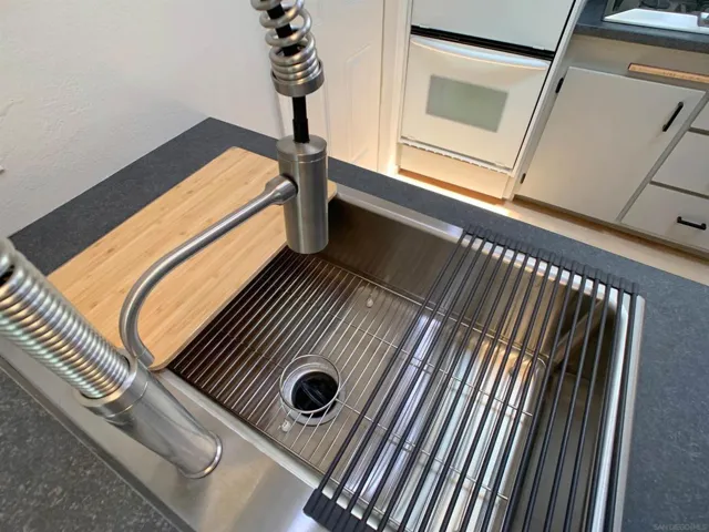New stainless steel sink and faucet with sprayer.