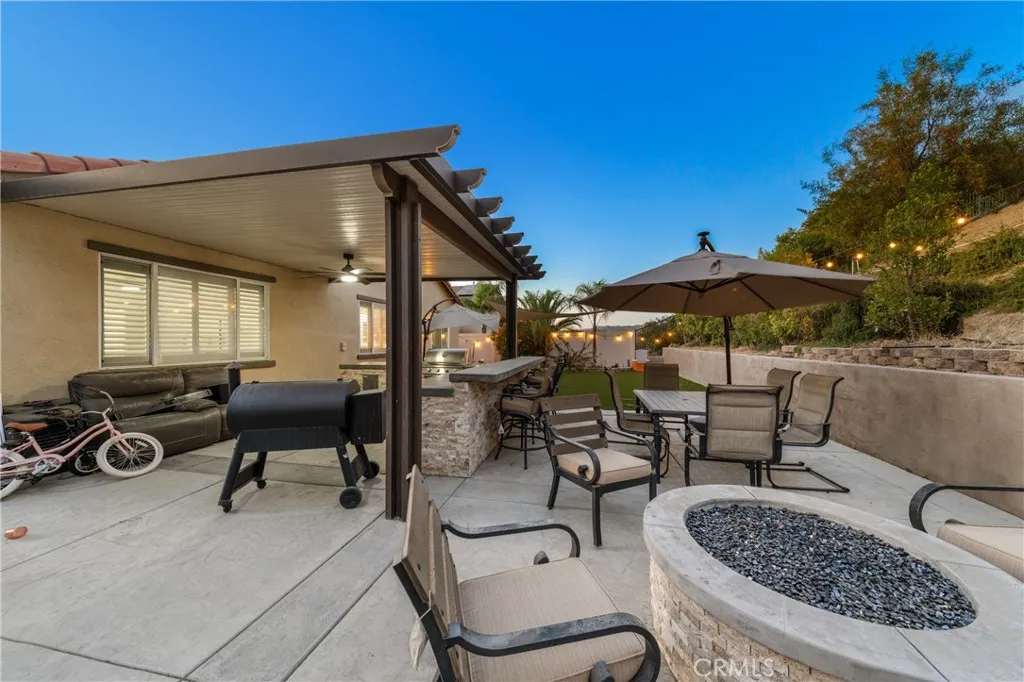 Patio with fire pit and BBQ island