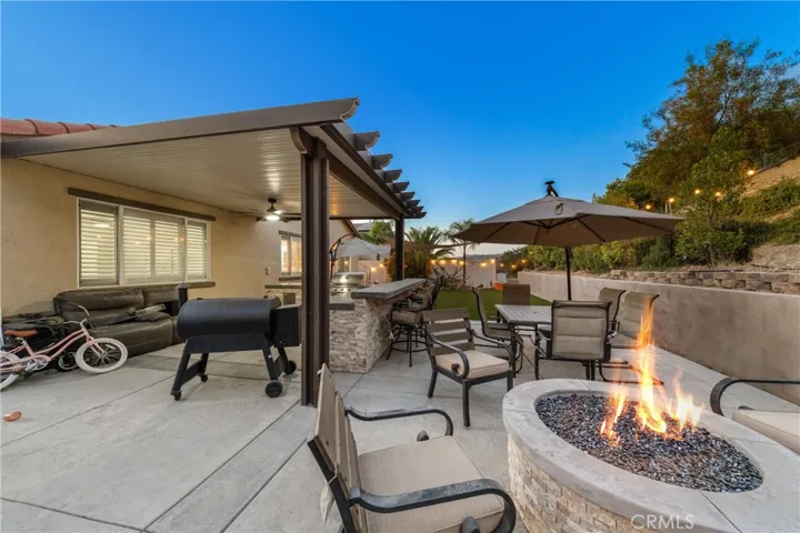 Patio with fire pit and BBQ island