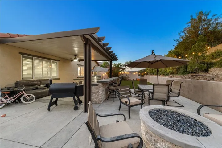 Patio with fire pit and BBQ island