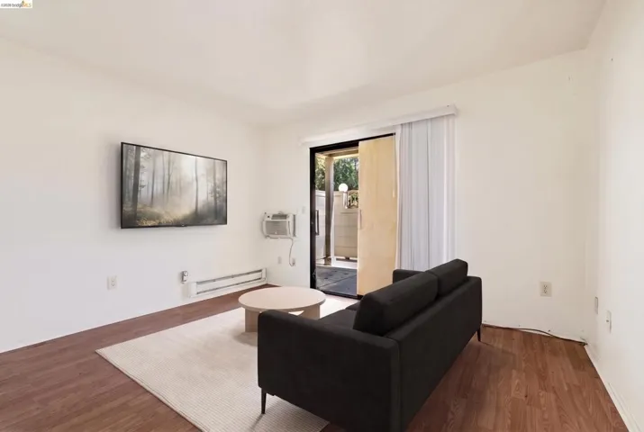 Living area featuring wood-finish flooring and a white wall finish