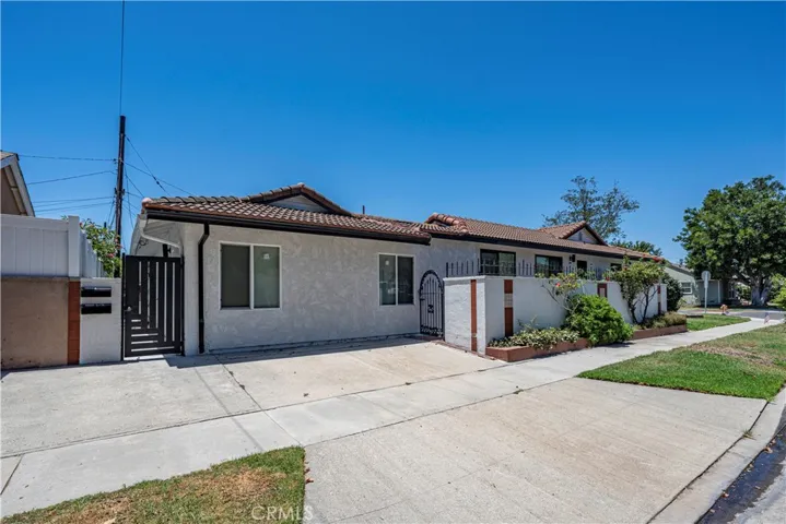 Private side patio off kitchen of main house, driveway with parking pad, and entry to both ADUs.