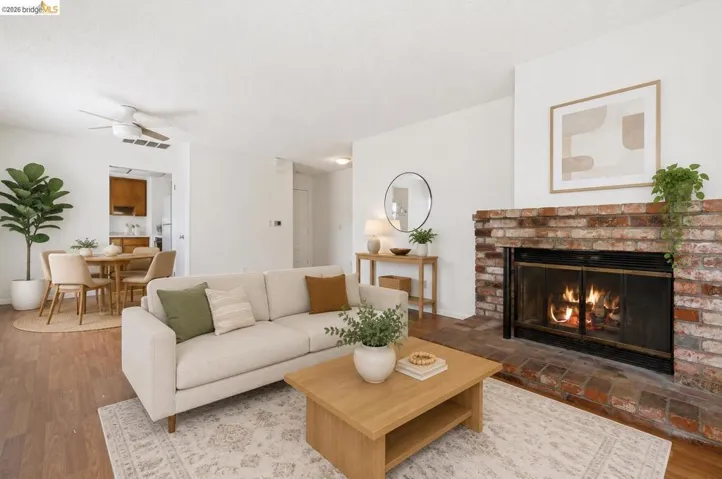 Living area featuring a brick fireplace with a black fire screen