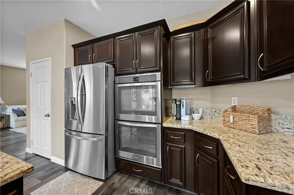 Well-equipped kitchen featuring a stainless refrigerator and built-in double ovens.