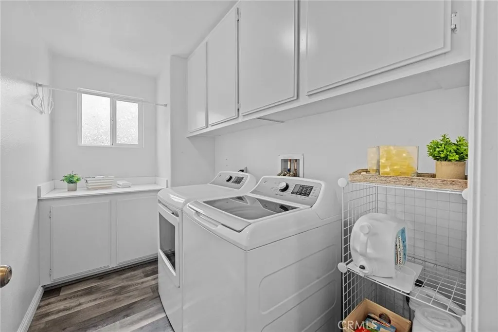 Dedicated laundry room with built-in cabinetry and ample storage.