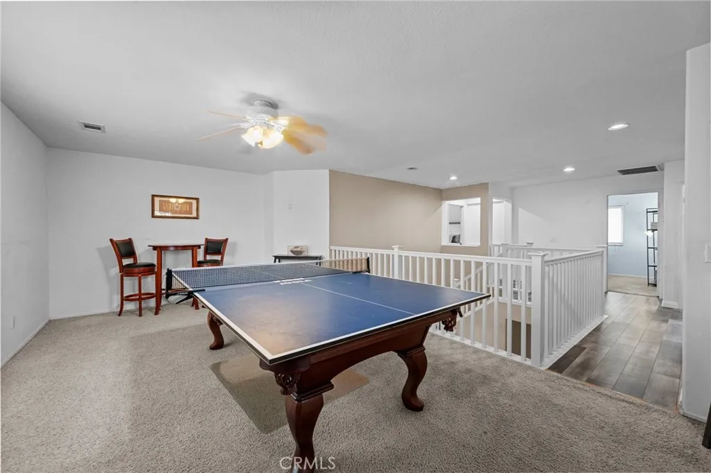 Versatile upstairs loft offers space for a game room, media area, or additional living space. The pool table and accessories are included in the sale.