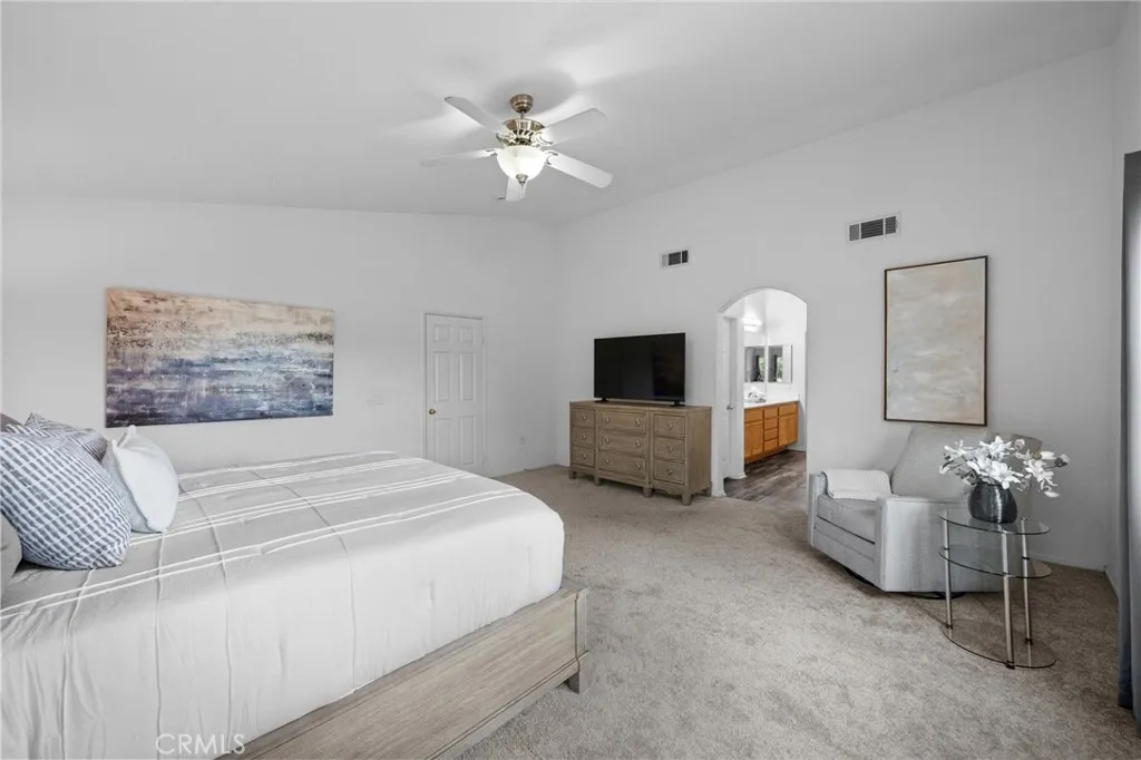 Spacious primary suite in the northwest corner, filled with natural light and plush carpet.