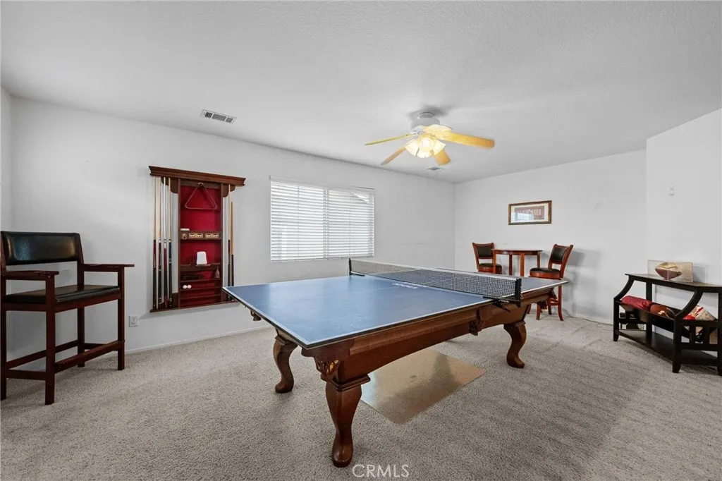 Versatile upstairs loft, with plush carpet, offers space for a game room, media area, or additional living space. The pool table and accessories are included in the sale.