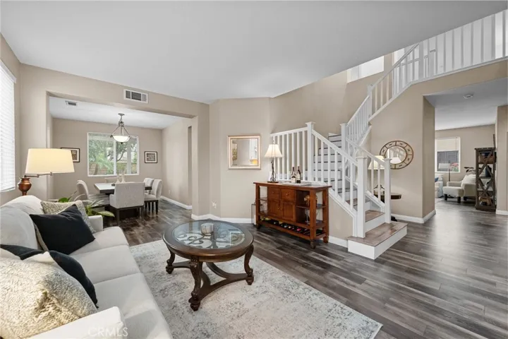 Elegant entry showcasing the open staircase and seamless flow into the living space.