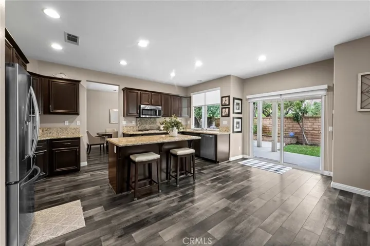 Well-appointed kitchen flows effortlessly to the backyard through sliding glass doors.