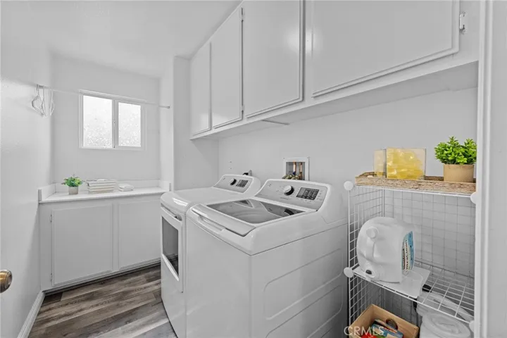 Dedicated laundry room with built-in cabinetry and ample storage.