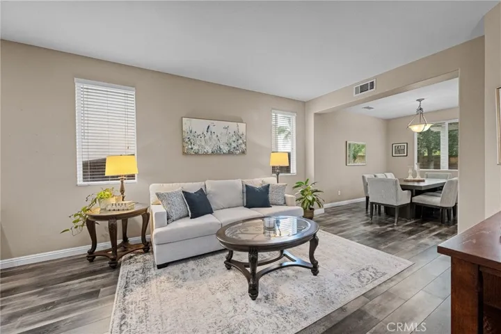 Bright, welcoming living room with a seamless view into the dining area.