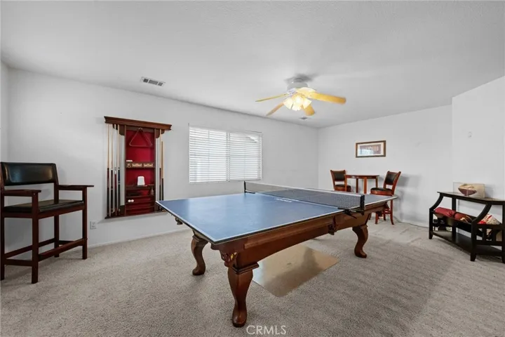 Versatile upstairs loft, with plush carpet, offers space for a game room, media area, or additional living space. The pool table and accessories are included in the sale.