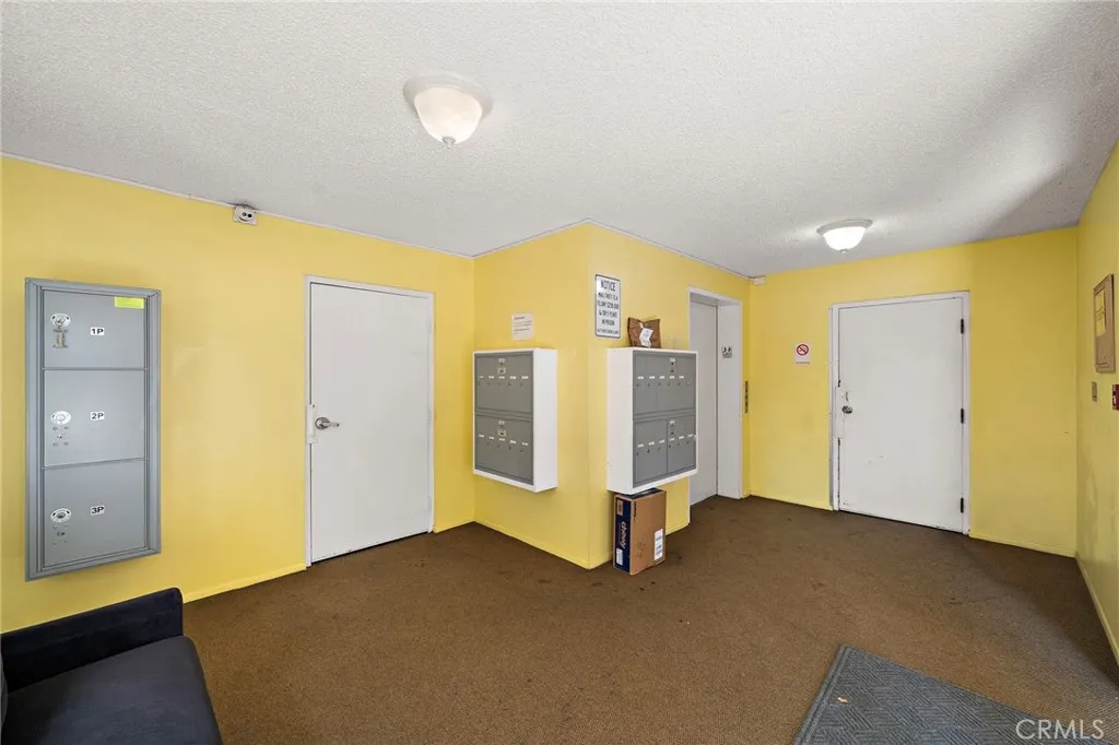 Lobby area stair access on the left and garage access to the right. mail boxes