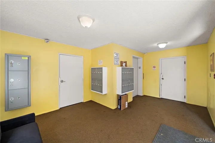 Lobby area stair access on the left and garage access to the right. mail boxes