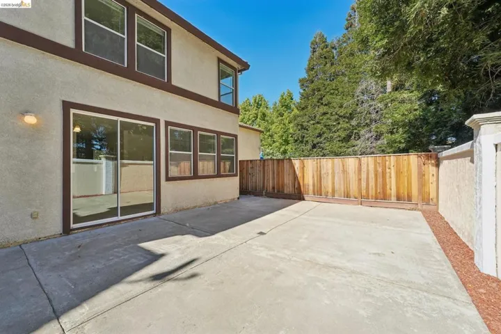 Expansive concrete patio with sliding glass door