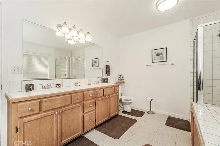 Primary bath offers dual sinks, a jetted tub and a large glassed in shower.