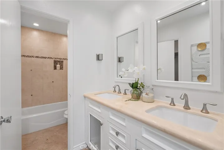 Primary ensuite w/double sinks, walk-in closet. Bath and shower behind door for added privacy.
