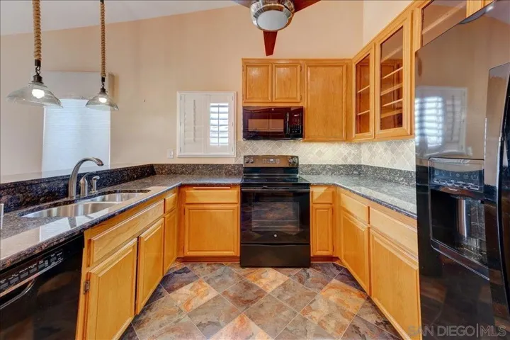 Kitchen opens up to the Family room/Den. The whole wall of pantry closets are very convenient(not deep).