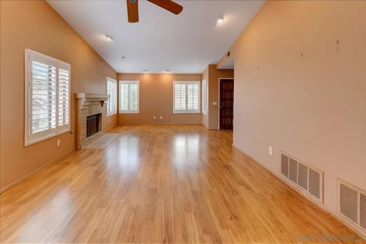 Great room offers vaulted ceilings and a fireplace. Tastefully decorated in warm hues the space gives you a happy and homey feeling.
