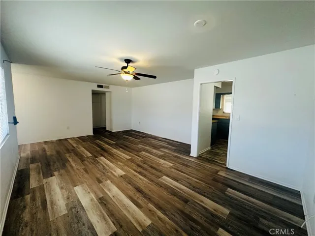 Living room with a glimpse into the kitchen.