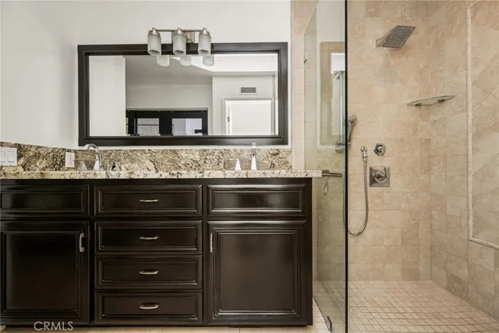Designer vanity with granite countertop and updated finishes.