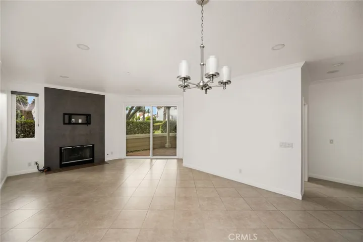 Light-filled dining area with fireplace and patio access.