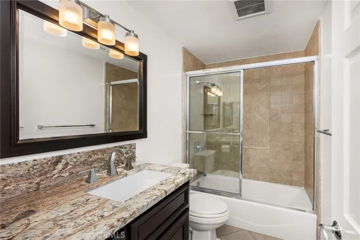 Updated secondary bathroom with granite vanity & tub/shower.
