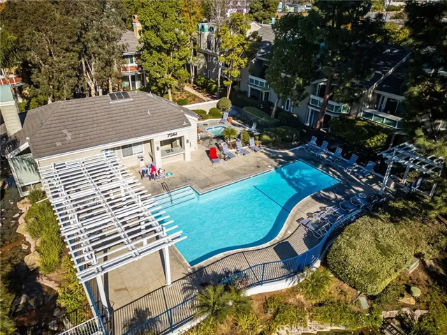 Resort-style pool, spa & clubhouse surrounded by mature landscaping.
