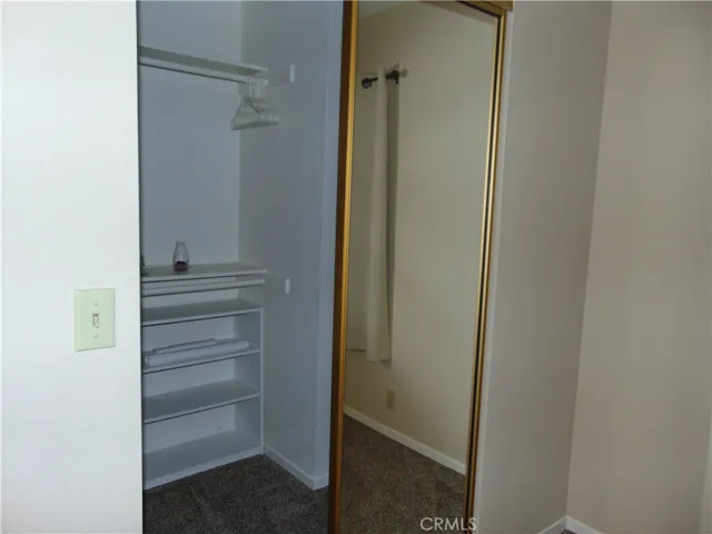 guest bedroom walk in closet,  mirrored  closet doors