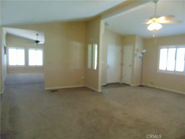 in living room from hall way, looking towards the front door and viewing formal dining room.