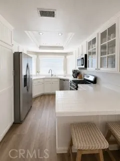 Charming Kitchen with bay window to front yard, counter seating, Refrigerator included with Lease