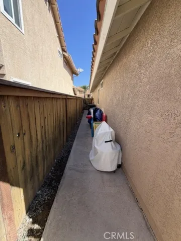 Cement walkway along back side of the home
Privacy fencing